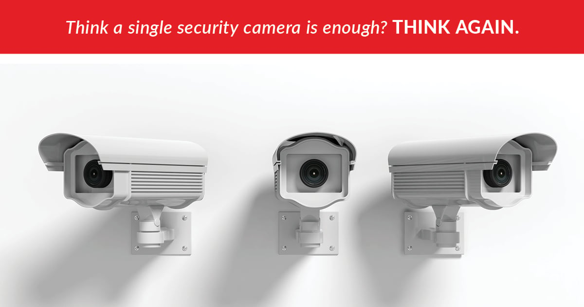three white security cameras next to each other on a blank wall